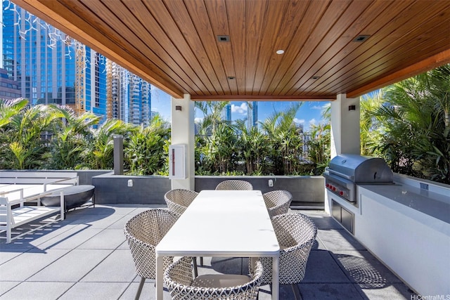 view of patio with grilling area, exterior kitchen, and outdoor dining area
