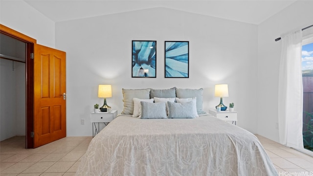 bedroom featuring light tile patterned floors and lofted ceiling