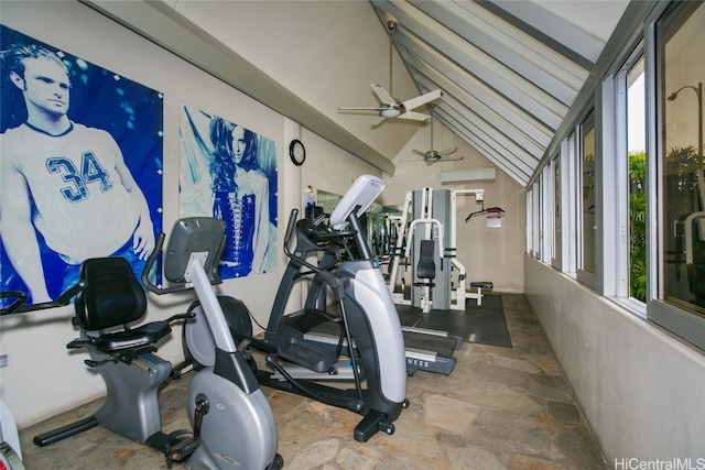 exercise room with ceiling fan and vaulted ceiling