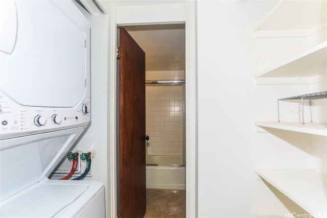 laundry area with stacked washer / dryer