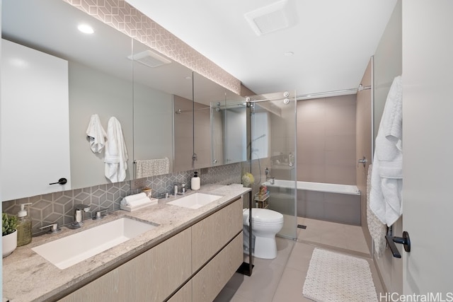 bathroom featuring decorative backsplash, toilet, vanity, an enclosed shower, and tile patterned floors