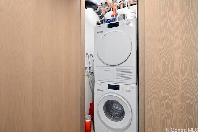 washroom featuring stacked washing maching and dryer