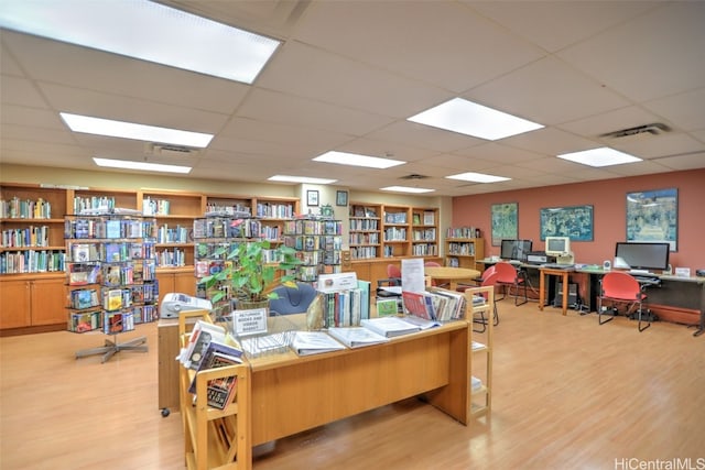 office featuring light hardwood / wood-style flooring and a paneled ceiling