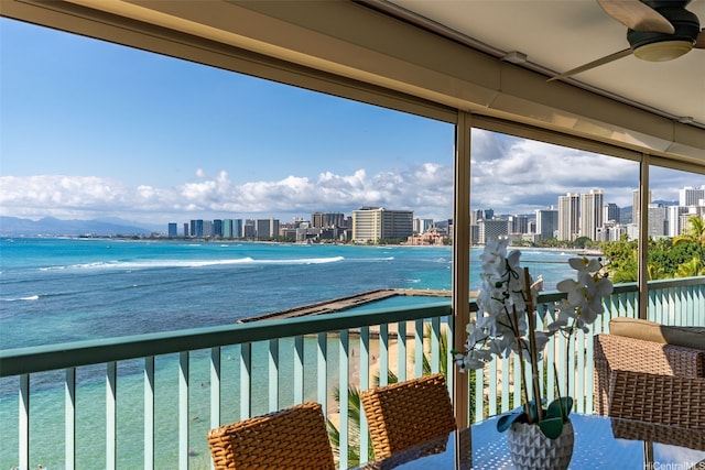 2877 Kalakaua Ave Unit 503/504, Honolulu, HI 96815 - balcony with a ceiling fan, a view of skyline, and a water view
