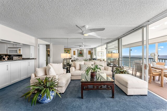 2877 Kalakaua Ave Unit 503/504, Honolulu, HI 96815 - carpeted living room featuring a textured ceiling, ceiling fan, and a water view