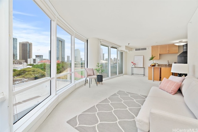 living room with sink and light colored carpet