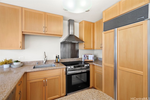 kitchen with appliances with stainless steel finishes, wall chimney exhaust hood, light stone countertops, and sink