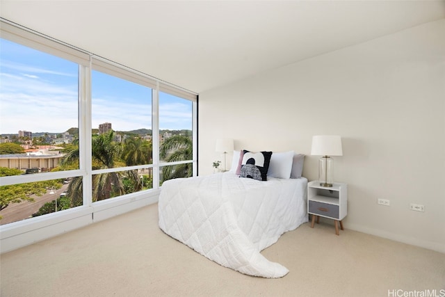 bedroom with multiple windows and light colored carpet