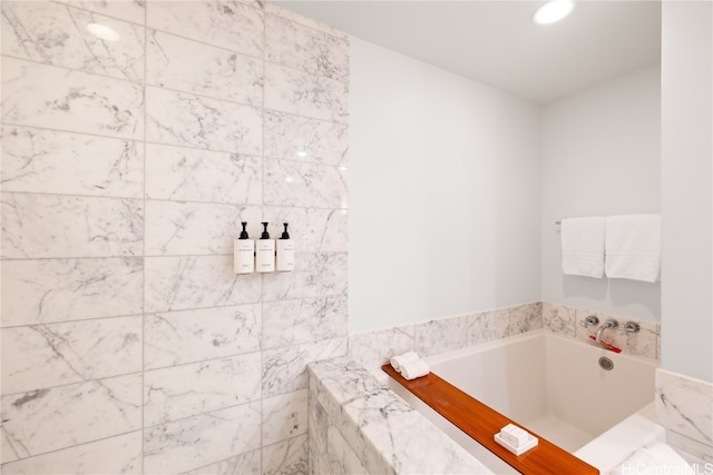 bathroom with a relaxing tiled tub