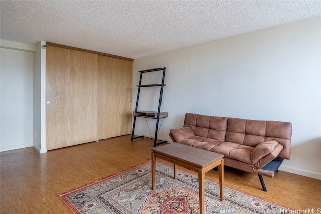 living room with a textured ceiling and hardwood / wood-style floors