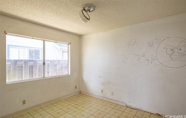 unfurnished room featuring a textured ceiling