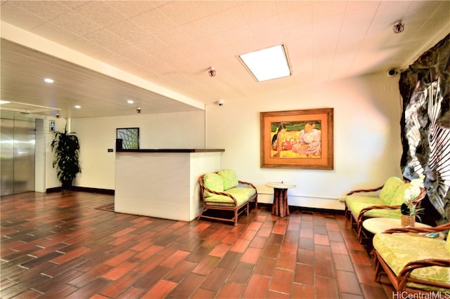 living area featuring dark hardwood / wood-style floors and elevator