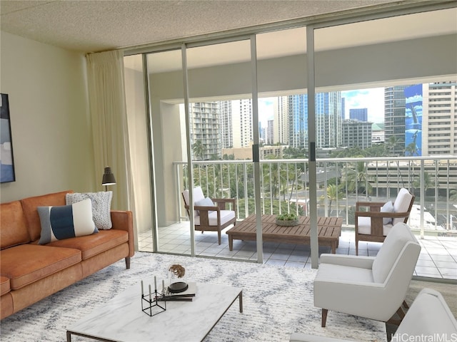 tiled living room with a wall of windows and a textured ceiling