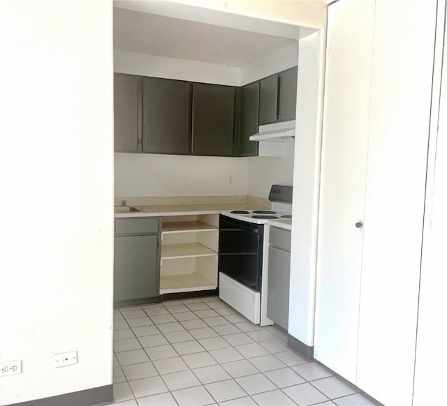 kitchen featuring sink, light tile patterned floors, and white electric stove