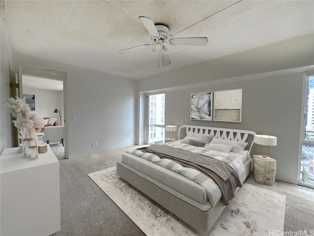 bedroom featuring ceiling fan, a textured ceiling, carpet, and multiple windows