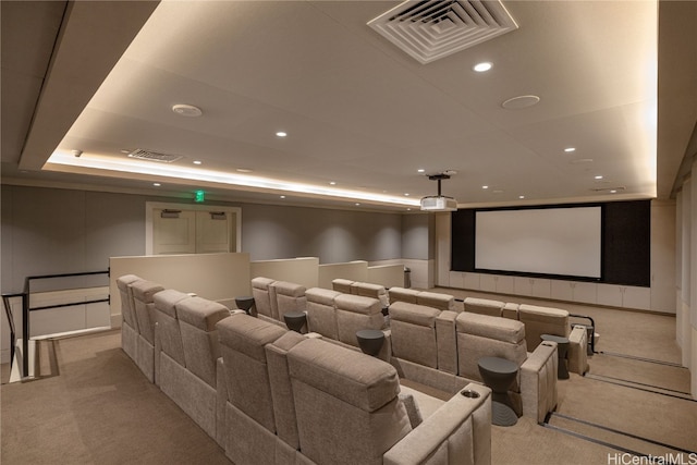 carpeted home theater with a tray ceiling