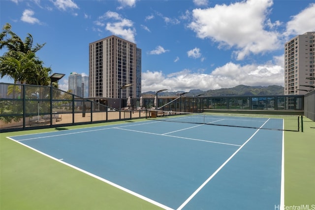 view of tennis court with a mountain view