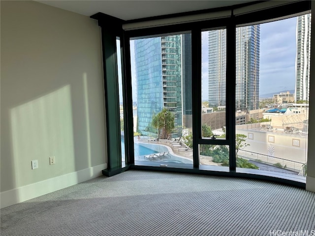 doorway with carpet and expansive windows