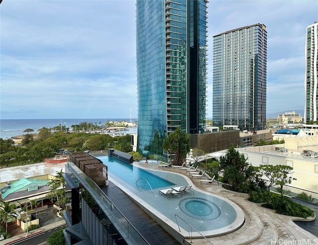 view of swimming pool with a water view