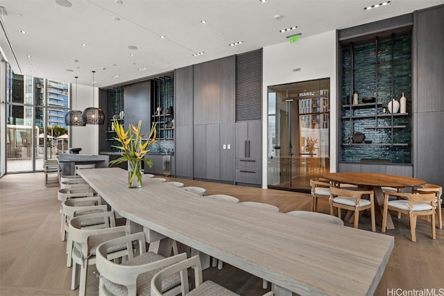 dining room with floor to ceiling windows and light wood-type flooring