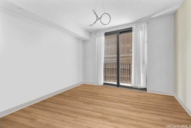 spare room featuring light wood-type flooring