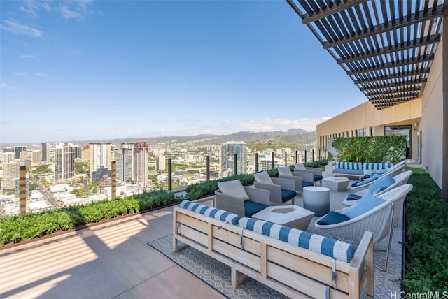 view of patio / terrace with a pergola, a mountain view, and outdoor lounge area