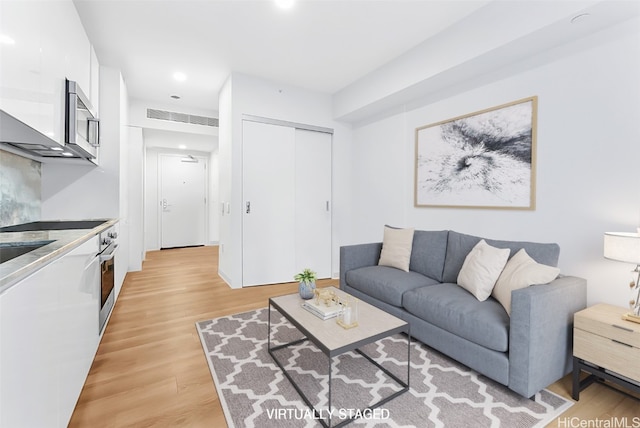 living room with light hardwood / wood-style floors