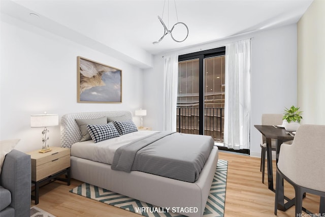 987 Queen St Unit 508, Honolulu, HI 96814 - bedroom featuring light wood-type flooring and access to outside