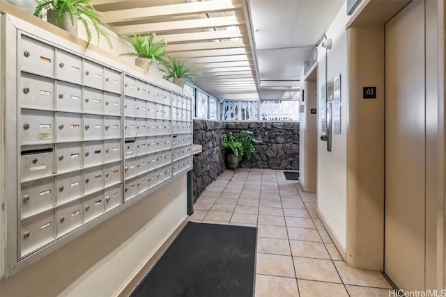 hall with a mail area and elevator