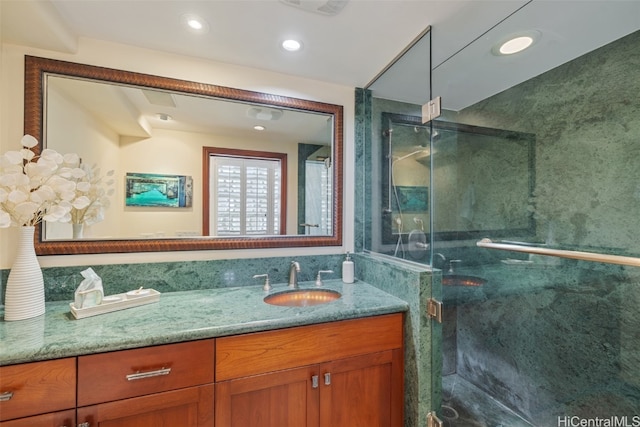 bathroom with vanity and a shower with shower door