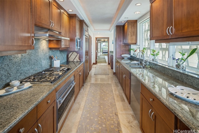 kitchen with stone counters, tasteful backsplash, sink, light tile patterned flooring, and stainless steel appliances