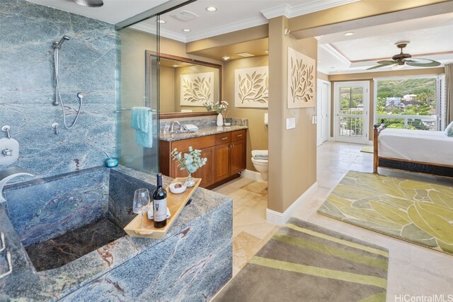 bathroom with tiled shower, toilet, ornamental molding, vanity, and ceiling fan