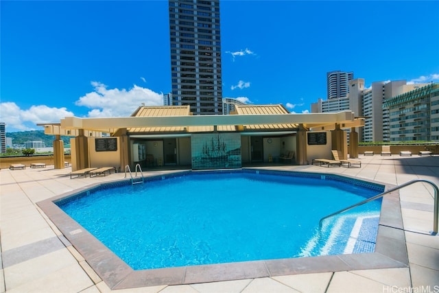 view of pool with a pergola and a patio