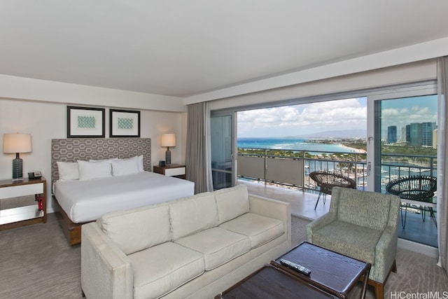 bedroom featuring access to exterior and a water view