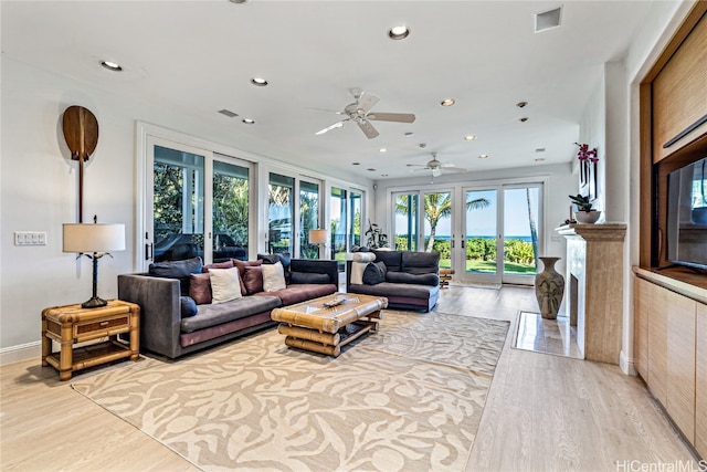 living room featuring light hardwood / wood-style floors and ceiling fan