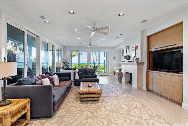 living room featuring light hardwood / wood-style flooring and ceiling fan