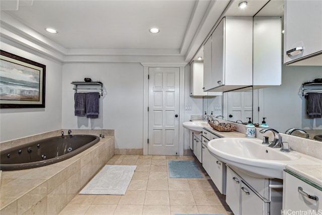 bathroom with vanity, a relaxing tiled tub, and tile patterned floors