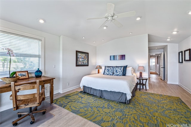 bedroom with lofted ceiling, light hardwood / wood-style floors, and ceiling fan