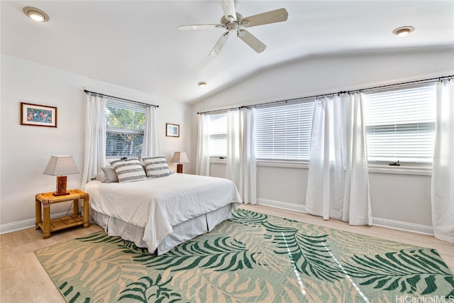 bedroom with light hardwood / wood-style floors, lofted ceiling, and ceiling fan