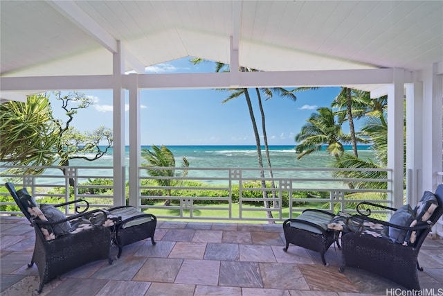 sunroom / solarium with a water view and lofted ceiling with beams