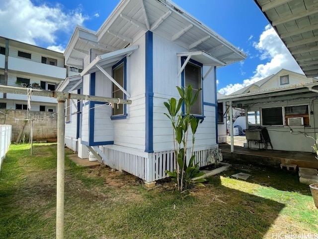 view of property exterior with a lawn