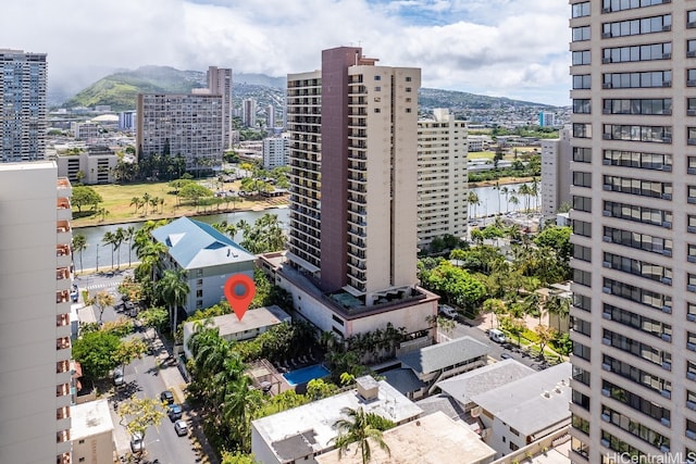 birds eye view of property with a water and mountain view