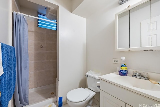 bathroom featuring vanity, curtained shower, and toilet