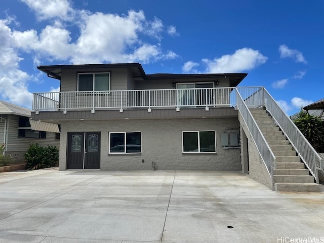 rear view of house with a balcony