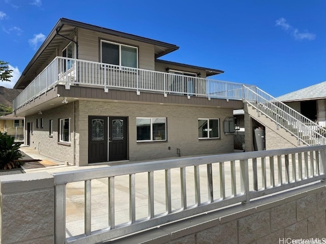 rear view of property featuring a balcony