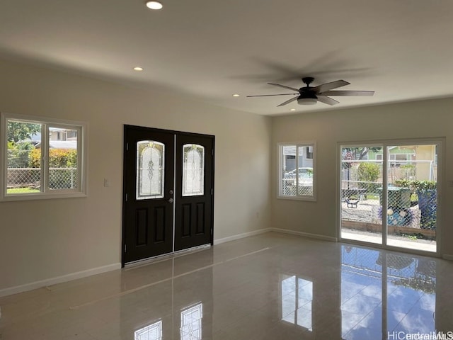 tiled foyer entrance featuring plenty of natural light and ceiling fan