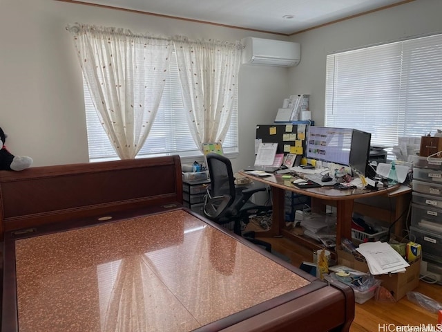 office area with a wall mounted AC, wood-type flooring, and a wealth of natural light