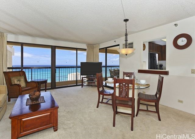 dining room with a textured ceiling and light colored carpet