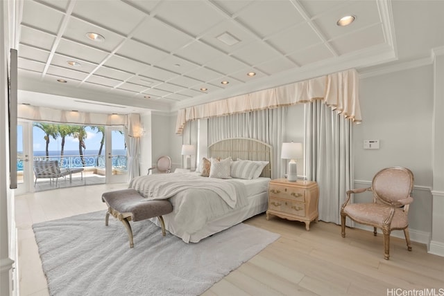 bedroom with access to outside, hardwood / wood-style flooring, crown molding, coffered ceiling, and a water view