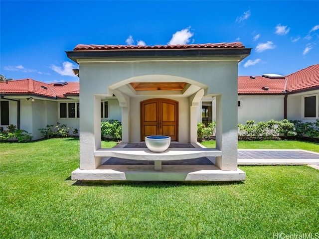 rear view of house with a yard